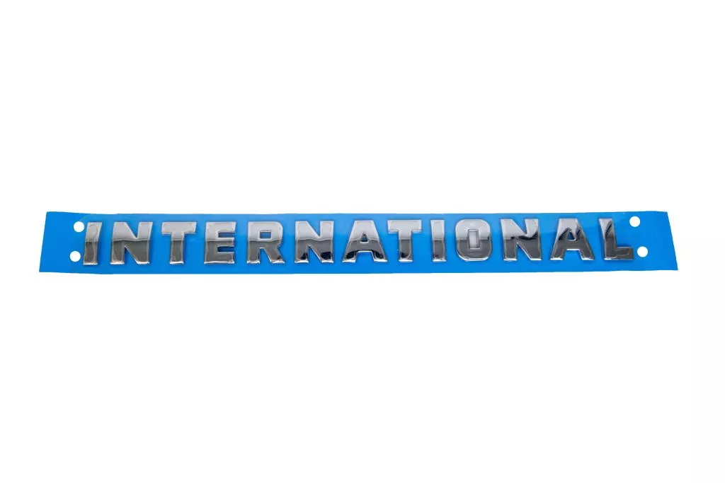 International Chrome Script Logo Badge